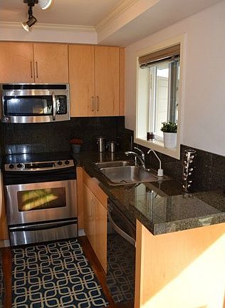 Stainless appliances, granite countertops, American cherry hardw
