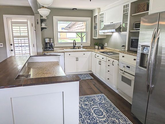 Kitchen with an island and open concept to den and dining area