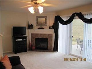 Relax in the Great Rm by the tile fireplace w/wood mantle!  Access to patio!