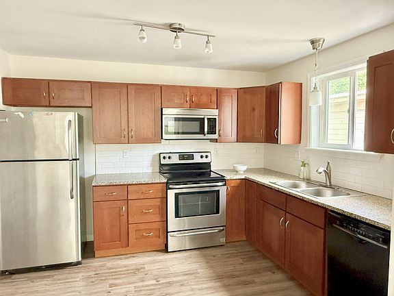Kitchen with stainless steel appliances including refrigerator/freezer, microwave, electric stove, in-sink garbage disposal, new Bosch dishwasher
