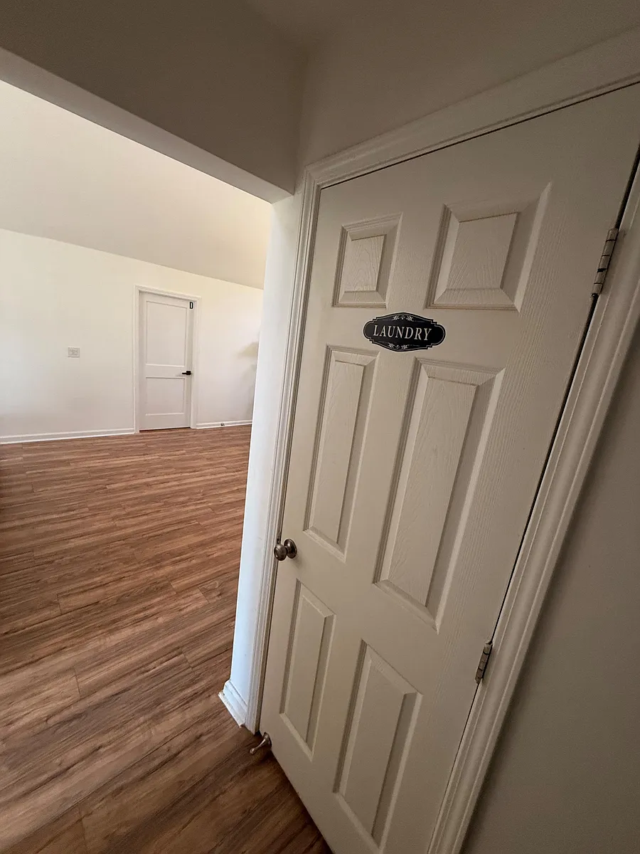 Convenient interior laundry area off the main living space, with easy-access doors and durable hard-surface flooring. - Trickum Hills Way