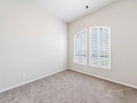 First of the secondary bedroom with plantation shutters could also be an additional office if needed.