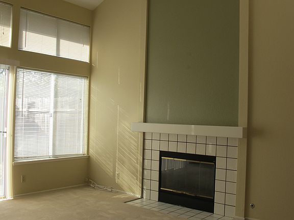 Living room with fireplace & skylights