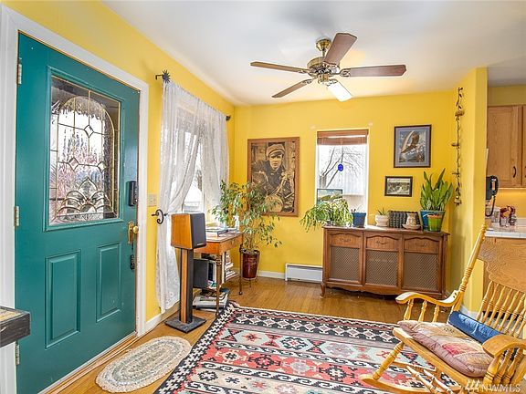 Beautiful entry from the front porch. Warm wood floors & cozy living area!