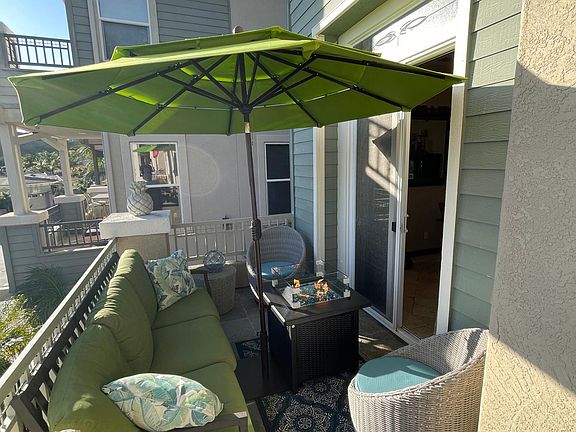 Cozy balcony area with fire pit and tilting umbrella