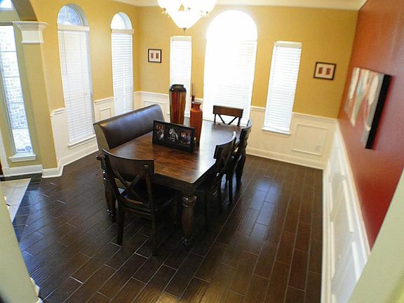 NIce dining area located off the front door, featuring those beautiful floors and more windows
