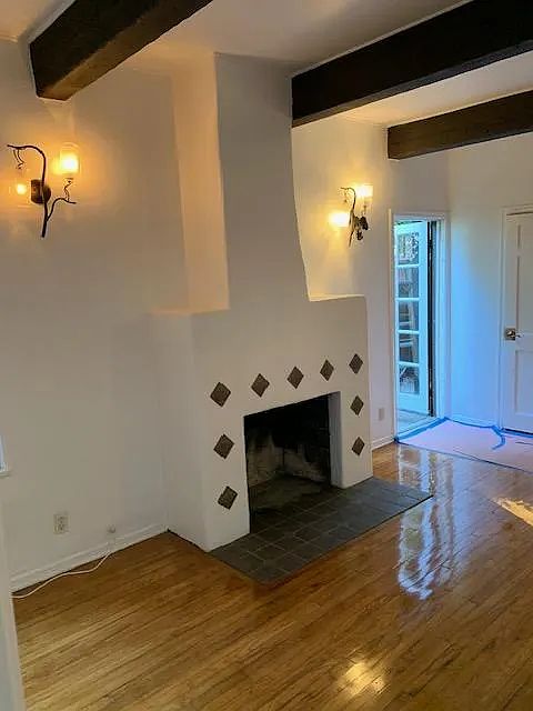 Cozy fireplace with beautiful wooden ceilings and beautiful floor greets you as you enter your new apartment!