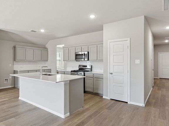 Kitchen in the Harrison home plan by Trophy Signature Homes - REPRESENTATIVE PHOTO