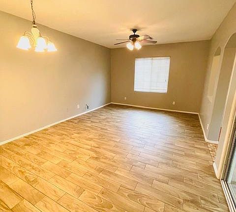 Spacious living room with plank tile floor.
