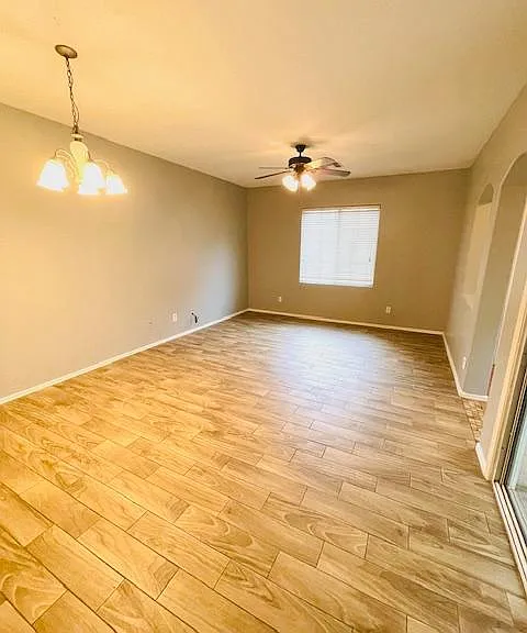 Spacious living room with plank tile floor.