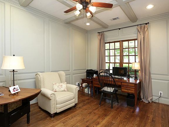 Front room/study has block paneling and hardwood floors.