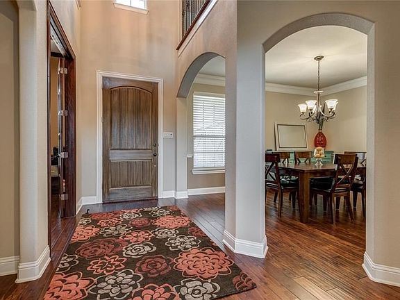Wood floors carry through from foyer through living, dining, study and halls.