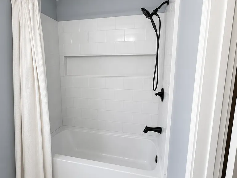 Primary bathroom with brand new tub shower installed in 2026