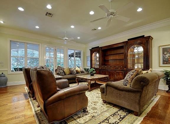 Beautiful interior with tall ceilings, crown and floor moldings and multiple windows.
