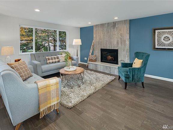 Beautiful  hardwood floors and custom wall tile and stone fireplace