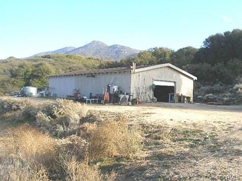 VIEW FROM COVERED FRONT PORCH OF MOBILE OF WORK SHOP