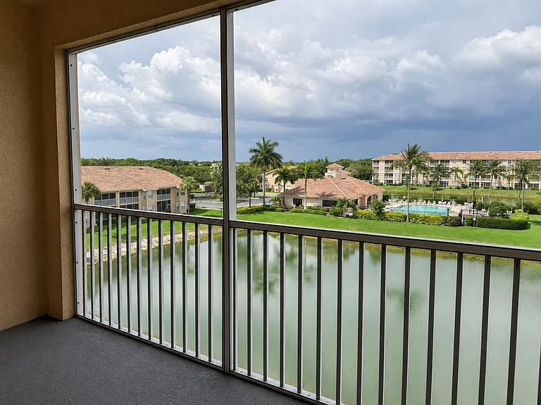 Screened lanai overlooking the lake and resort-style community pool