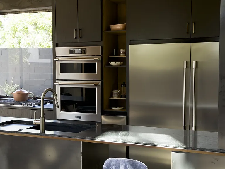 Industrial fridge, double wall oven, natural-gas stove, stand-alone ice maker, beverage fridge and dishwasher.