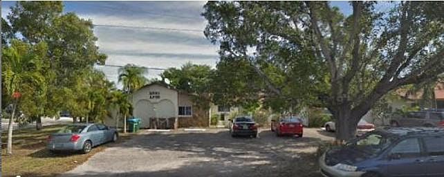 Front view, private parking lot and courtyard