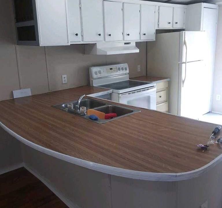 Kitchen with counter bar and glasstop stove