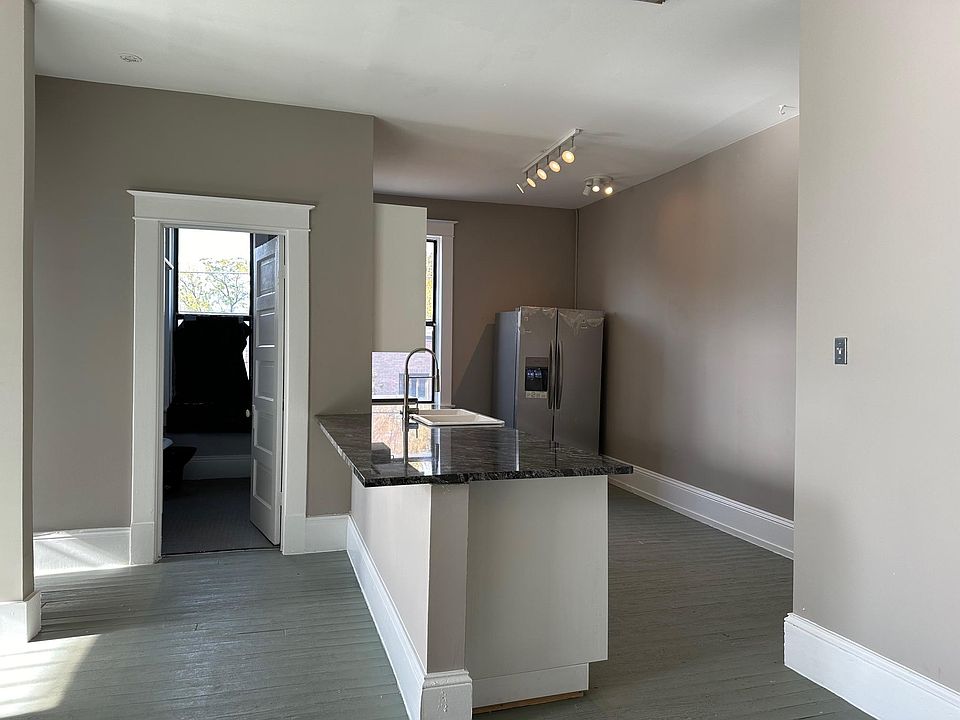 view to bathroom door and kitchen