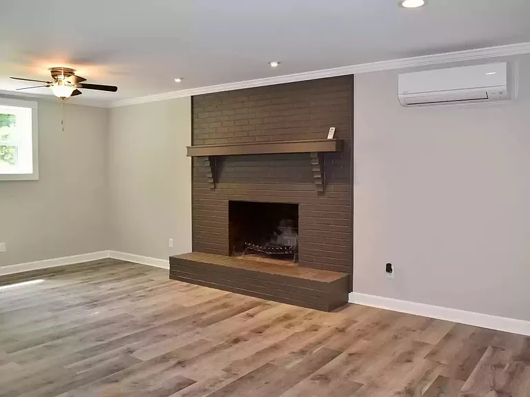 Huge Bonus Room downstairs with wood burning fireplace.