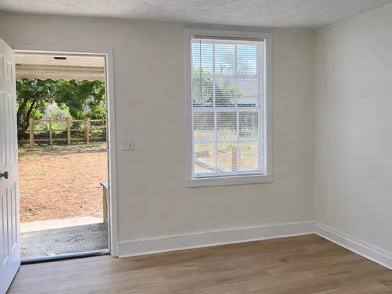 Bright living space with natural light and direct exterior access