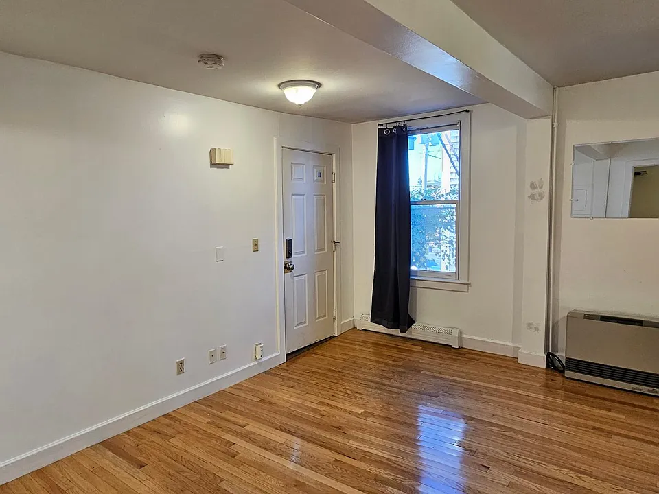 Main living area, lovely hardwood floors and high ceilings. Large windows that let in light, help keep out noise. Rinnai wall heater heats the entire apartment.