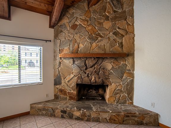 Large, stone , wood burning fireplace.