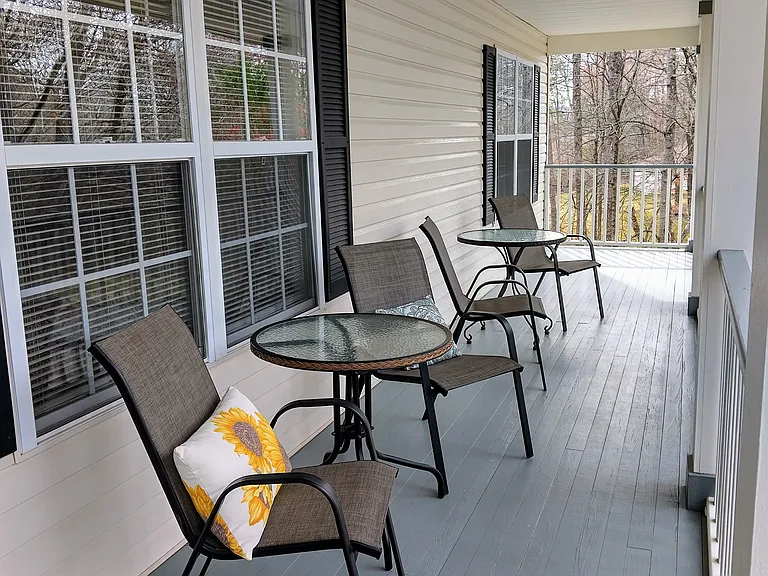 The cozy porch allows plenty of seating for relaxing and enjoying the surroundings, along with dawn-to-dusk light fixtures.