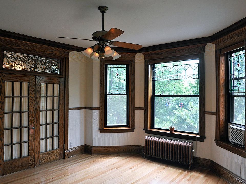 Front room with french doors that lead to a bedroom that has a bevelled stained glass window