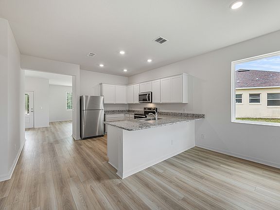 Gorgeous upper-wood cabinets with crown molding provide plenty of storage space