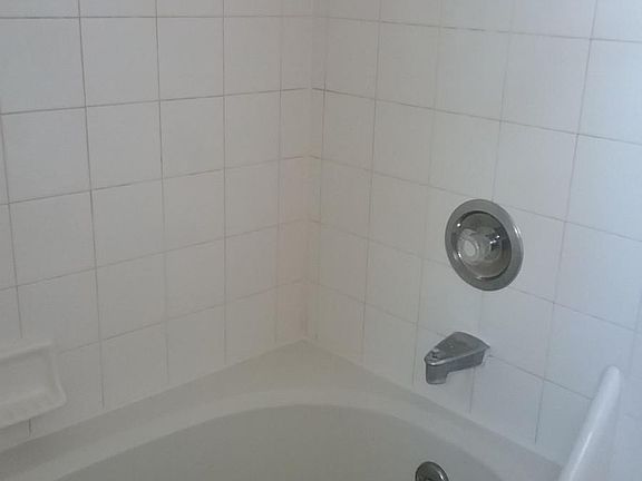 The bathroom features a relaxing jacuzzi tub
