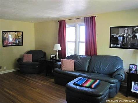Living room has oversized windows for plenty of natural light.