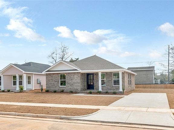 Ranch-style house with brick siding, roof with shingles, and driveway