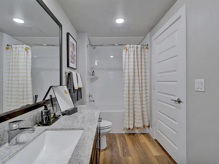 Large mirror vanities and plentiful storage in bathrooms.