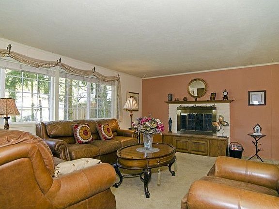Another picture of this spacious living room with fireplace.