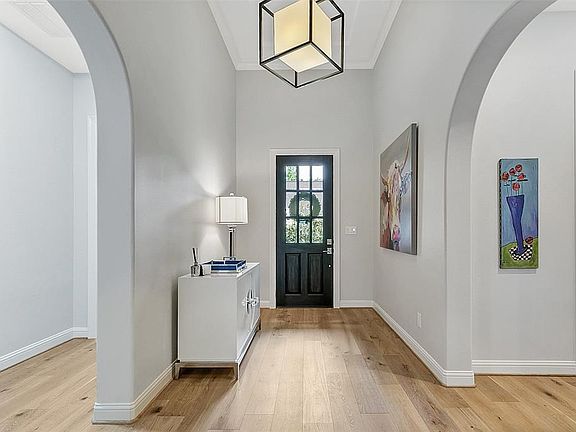 Architectural details include rounded corners, arched doorways, and extensive crown molding.