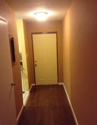 Front door with kitchen on right