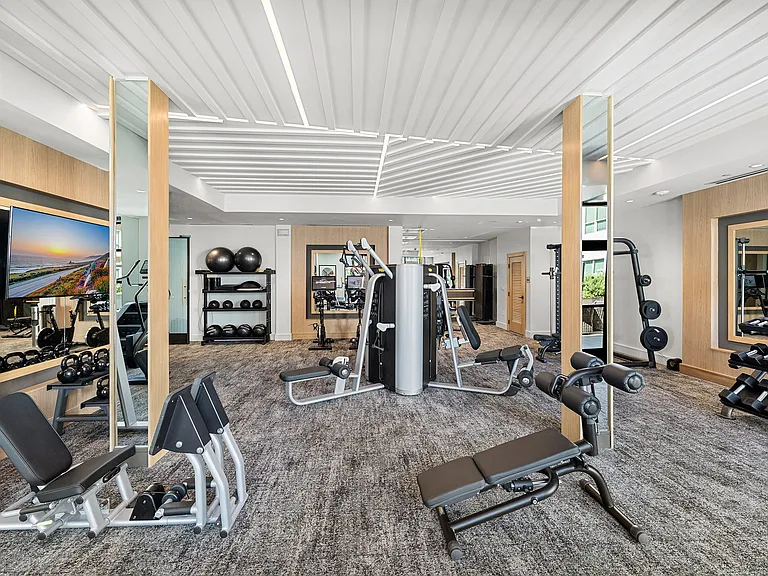 Gym with strength equipment, kettlebells, and open space