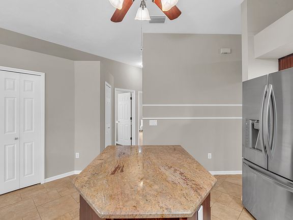 kitchen and hallway that leads to the the additional bedrooms