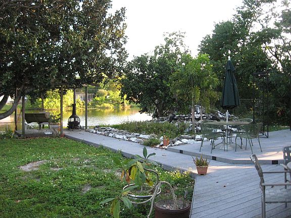 View of deck, gazebo, waterfall and lake in back