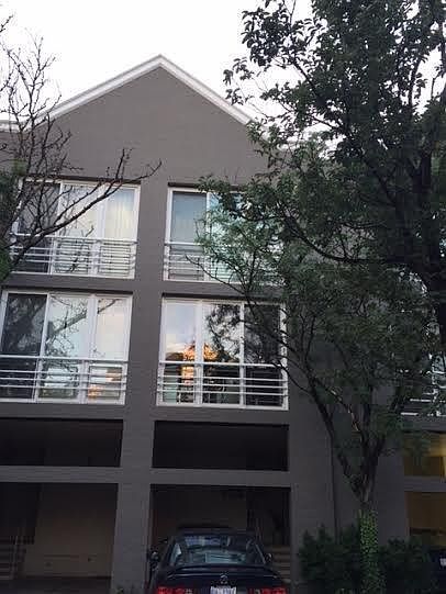 Outside of townhome. Shows covered and extra parking space.