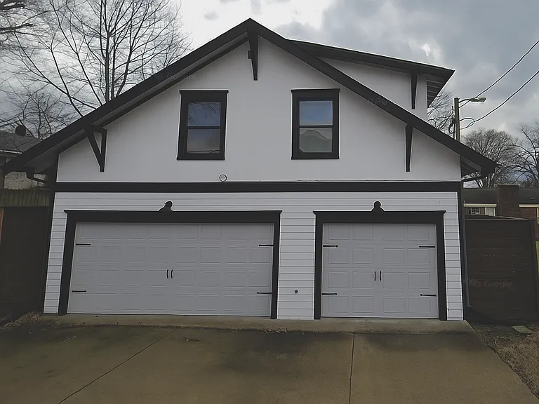 1 car garage on the right available. Apartment located above garages. Gate on right leads to a second private entrance. Note: This photo has been edited to show the home's current colors _ it used to be pink!
