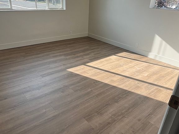 main bedroom from doorway, lots of natural light and has a ceiling fan