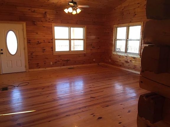 Living room with door to road side and front of house