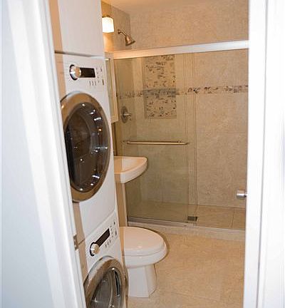 Upstairs bathroom including washer and dryer