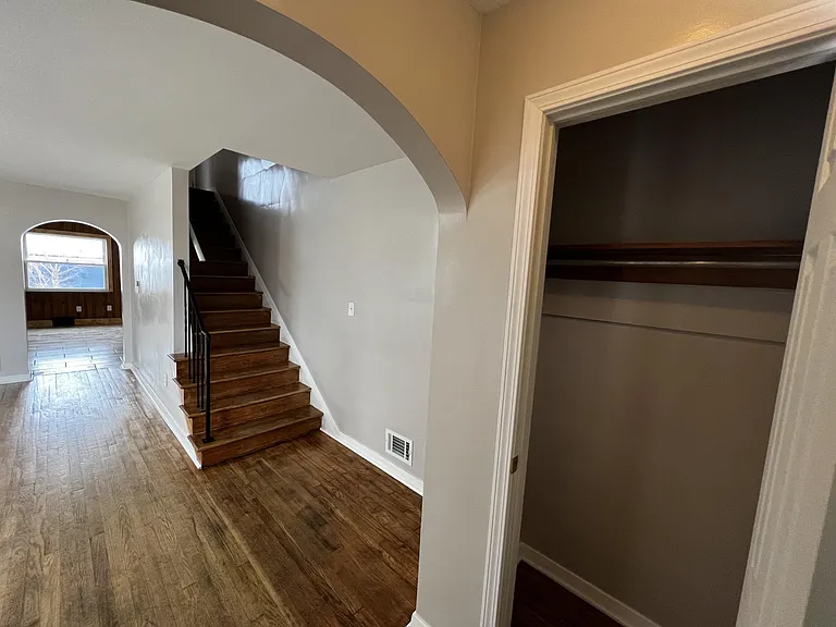 Front entryway and coat closet with refinished, hardwood floors throughout.