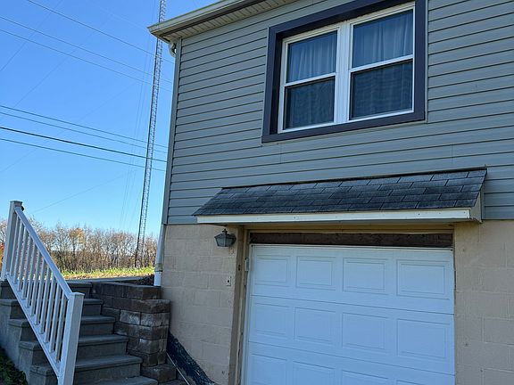 One car garage and steps leading up to the covered front porch, great for guests to enter