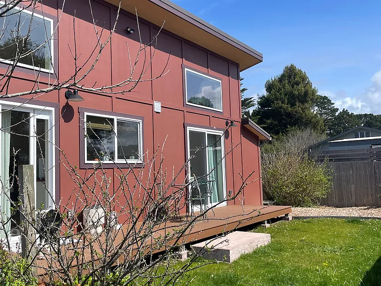 The south side of the home with the new lawn coming in.